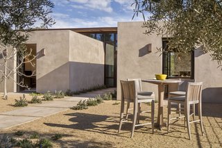 The library, kitchen, and master suite are housed within the plaster cubes.
