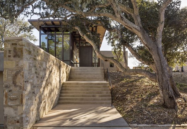 Stone walls, made with rock excavated on site, frame the ascent with cement steps.