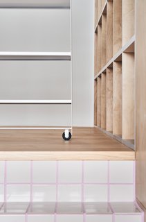 The stairs are mounted on wheels so that they can be moved out of the way when residents need to access storage.