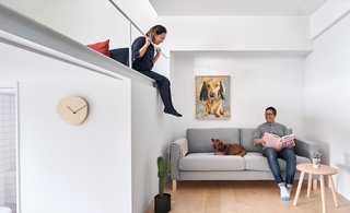 The mezzanine safety railing is made thin and painted white to minimize its appearance.