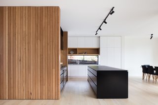 The kitchen island is covered with a Dekton countertop.