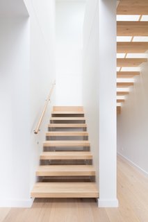 Open-riser stairs lead up to the master suite.