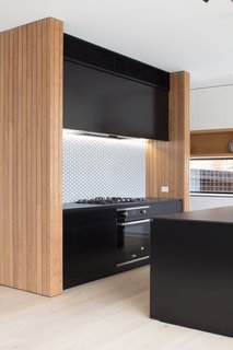 The kitchen is fitted with a Highland ceramic glass cooktop and a built-in oven.