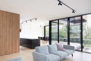 White-painted plaster walls and tall ceilings make the living space feel bright and airy.