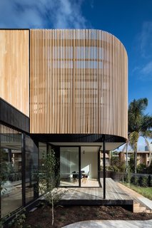 The curved battened screen provides privacy for the master suite and gives the extension sculptural appeal.