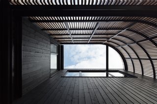 The view from the outdoor patio looking up and inside the curved battened screen.