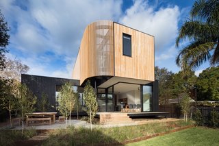 The lower level of the Ivanhoe extension is wrapped in black-stained timber, while the upper portion features blackbutt vertical cladding.