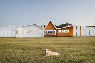 An 8-kW solar array powers the majority of the home's annual energy use, while a five-ton geothermal system provides mechanical heating and cooling. A 30,000-gallon rainwater collection system feeds the home with 200 gallons of purified water daily.