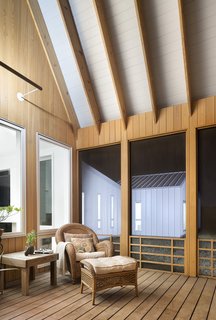 The enclosed screen porch is enveloped in locally sourced cypress.