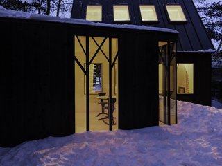 Black steel covers the roof, while the exterior walls are wrapped in charred cedar.