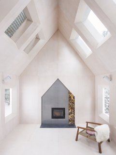 A total of 14 windows punctuate the living room, with half of them overlooking peripheral rooms to give the cabin a house-within-a-house feel.