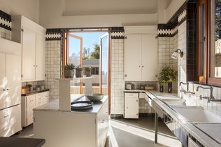 Lovely tilework lines the restored kitchen.