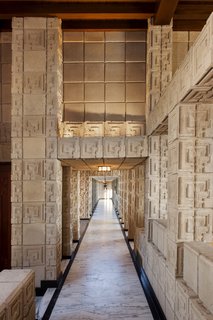 A long, low-ceilinged loggia with marble floors leads to the master bedroom.