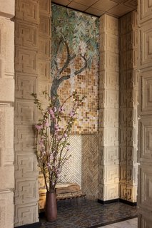 This stunning Wisteria glass-mosaic placed above the living room fireplace is one of only four of its kind ever designed by Wright, and is the only extant example.