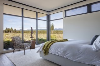 Full-height glazing wraps around the south-facing side of the master bedroom.