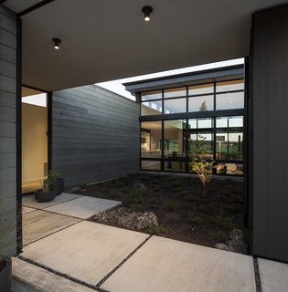 A look inside the entry courtyard flanked by the office to the west, the living area to the south, and the entrance to the east.