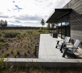 Aluminum-framed sliding doors connect the living room to an outdoor patio.