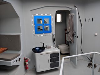 The bathroom is equipped with a Bosch on-demand water heater, as well as a Panasonic bathroom fan and air-to-air heat exchanger ventilation system.