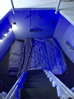 A queen-size bed is located down below and accessible via ship ladder.