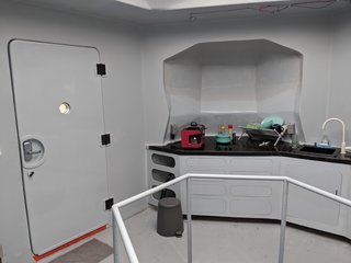 The galley kitchen features counters also built with SIP construction. The counters are layered with epoxy, along with carbon fiber on top.