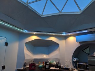 LED strip lighting and recessed ceiling lights illuminate the space at night.