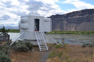 The sewer, water, and electrical lines are attached along the legs of the building.