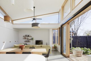 "The triangular highlight frames views of the old Edwardian pressed metal roof and chimneys," the architects say of the triangular window to the left. "Like a traveler reflecting upon their hometown from abroad, we look back at the original part of the house, see its foibles and imperfections, and love it all the more for these eccentricities."