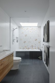 A strategically placed skylight bathes the shower area in natural light.