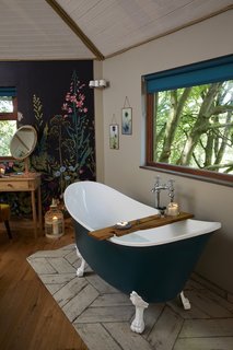 The roll-top freestanding bath overlooks beautiful valley views.