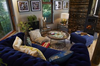 The Deluxe Chesterfield Sofa is the perfect place to kick back in front of the wood-burning stove. A game of Monopoly rests on a Katherine coffee table.