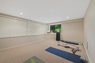 The laundry room, utility room, and gym are on the lower level with access to the rear lawn.