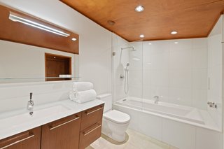 The master bathroom is fitted out with radiant heat, high-end Duravit fixtures, and a glass-capped vanity.