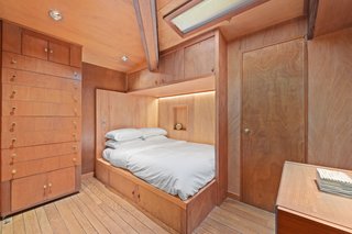 The "hotel" bedroom is crafted from mahogany with extensive built-in furnishings. The bathroom is down the hall.