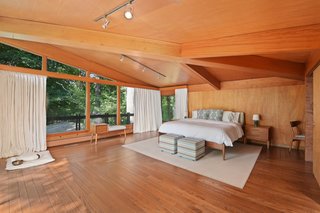 Located off the great room, the magnificent master suite is finished in mahogany with a vaulted ceiling and built-in desk.