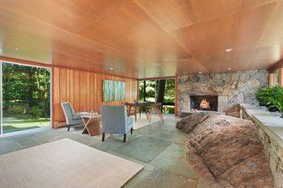 One of the most dramatic examples of site integration, the family room is built around a natural rock outcropping and finished with a slate floor and stone fireplace.
