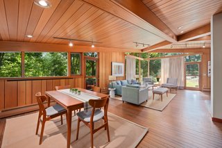 A vaulted ceiling delivers drama to the great room, which brings the outdoors in through floor-to-ceiling, mitered windows set in dramatic angles.
