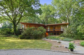 A view of the home's south elevation from the gravel circle parking pad.