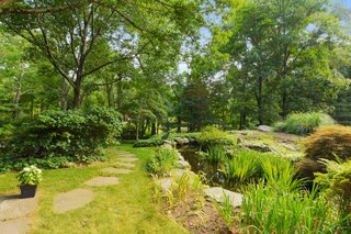 The property also includes a landscaped koi pond with ornamentals.