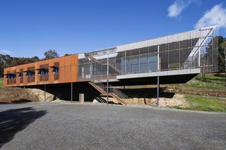 Outdoor stairs lead to an accessible rooftop deck that offers 360-degree views. Kliplock metal sheeting clads the roof.