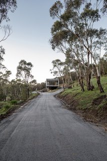 Nestled into the side of Mount Macedon, the home is on a remote site surrounded by nature, yet still within a commutable drive to Melbourne.