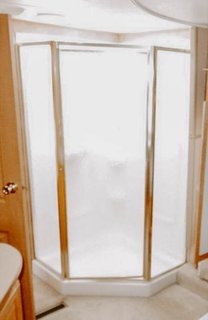 The enclosed shower looked busy with its metal framing.