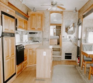 A look at the former kitchen leading to the bedroom in the rear.