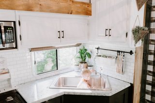 The upper cabinets were repainted with Rustoleum White Chalk paint, while new stick-on subway tile (from Tic Tac Tile) was applied to the backsplash.