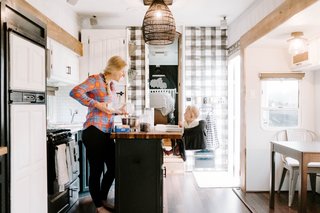 "When people walk into the RV, the kitchen is the first thing they notice," notes Lauren. "We added a stick-on backsplash, painted the upper and lower cabinets, added the utensil holder, knife magnet, painted the spice rack, and added the butcher block island top. We cut it a little long so there was enough overhang for our daughter’s highchair."
