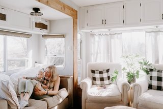 The couple added all new furniture, from the sofas and chairs to the lighting fixtures and curtains. To stay within budget, the larger furniture finds were either gifted, or purchased at secondhand stores.