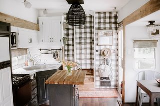 The couple didn't cover all the walls with paint. Instead, they applied Buffalo plaid wallpaper (from Home Depot) to select areas.