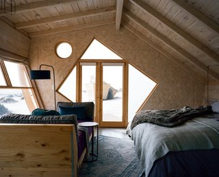 The asymmetrical shape and tilted lines reinforce the impression that the cabins are capsized ships.