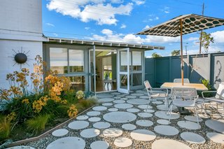 The outdoor dining area is accessible from the open-plan great room.