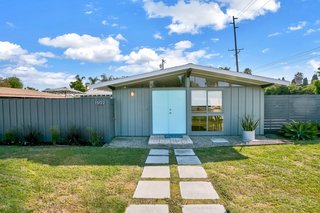 Set on a 7,875-square-foot lot, this Cliff May-designed Tustin home comes with a detached garage with two covered parking spaces.