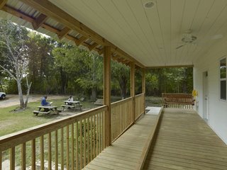 The layout of Turner’s Home features a long, narrow porch that spans the front facade of the house. Inside, the living room, kitchen, and bedroom all face the porch. The home also features the 20K project’s first tornado-safe room. The room, which doubles as the home's roll-in shower, features FEMA recommended construction, and is structurally separate from the rest of the house.